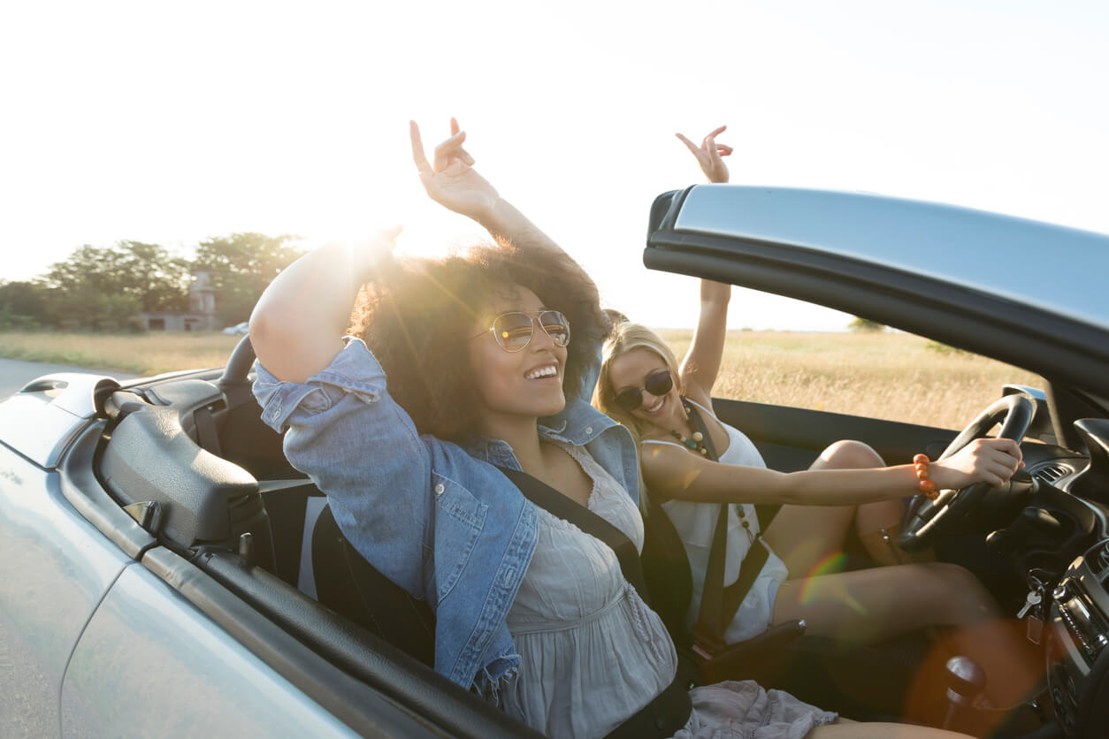 Teen Driving Accidents two teen girls in convertible driving and having fun